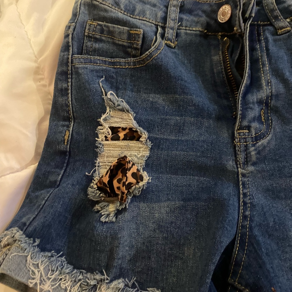 Brand new size 2 jean shorts with cheetah pockets